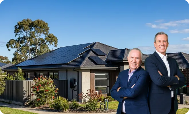 Allan Border and Glenn McGrath standing in front of a modern Greater Melbourne home with black monocrystalline solar panels.