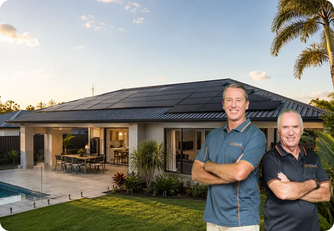 Allan Border and Glenn McGrath standing in front of a modern Queensland home with black monocrystalline solar panels.