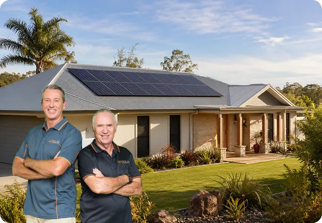 Allan Border and Glenn McGrath standing in front of a regional Queensland home with black monocrystalline solar panels.
