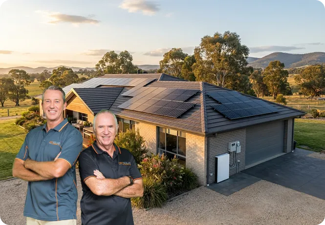 Allan Border and Glenn McGrath standing in front of a regional Victorian home with black monocrystalline solar panels.